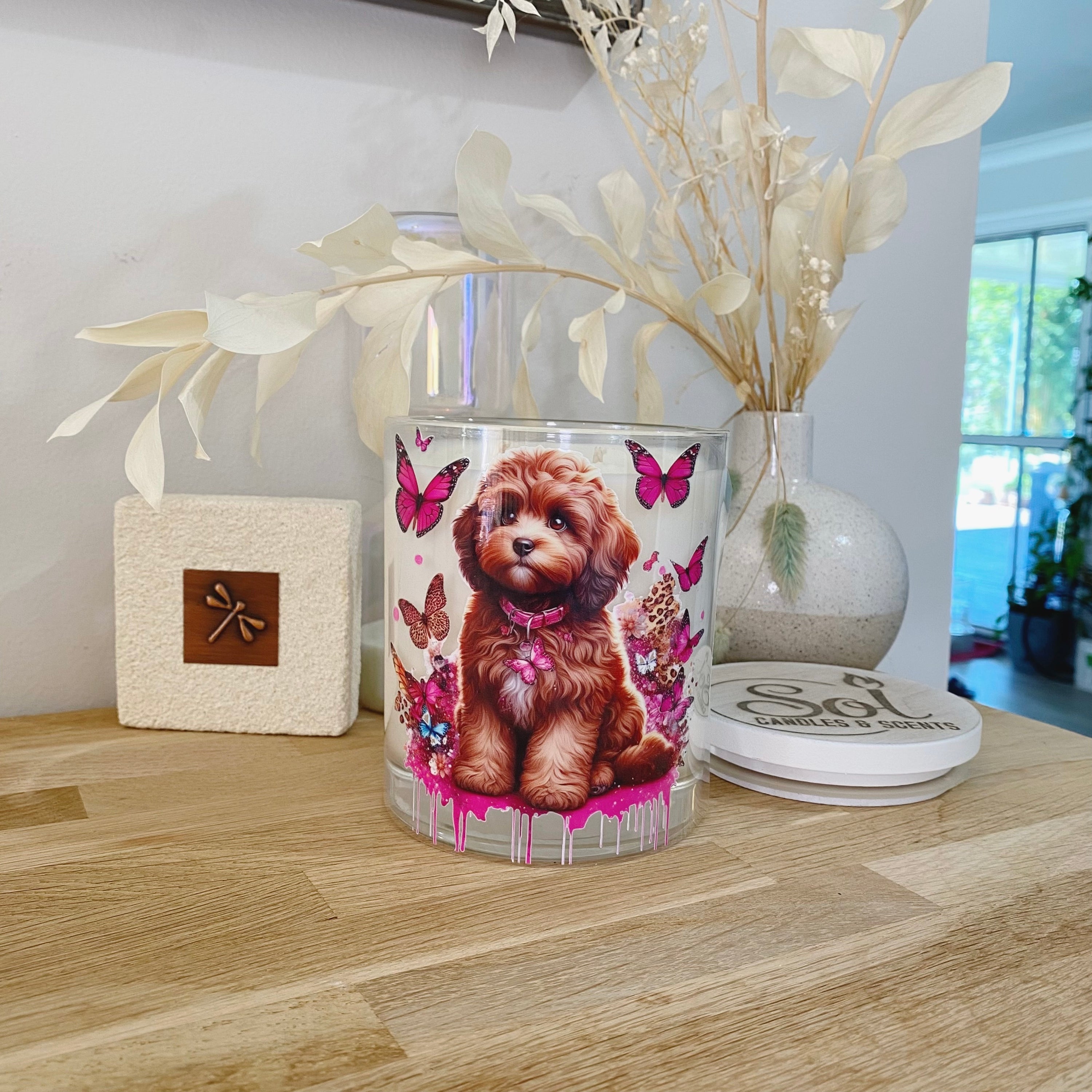 Cavoodle Chocolate Dog Sitting Surrounded with Butterflies on an Xlarge Candle_Designed by Sol Candles & Scents