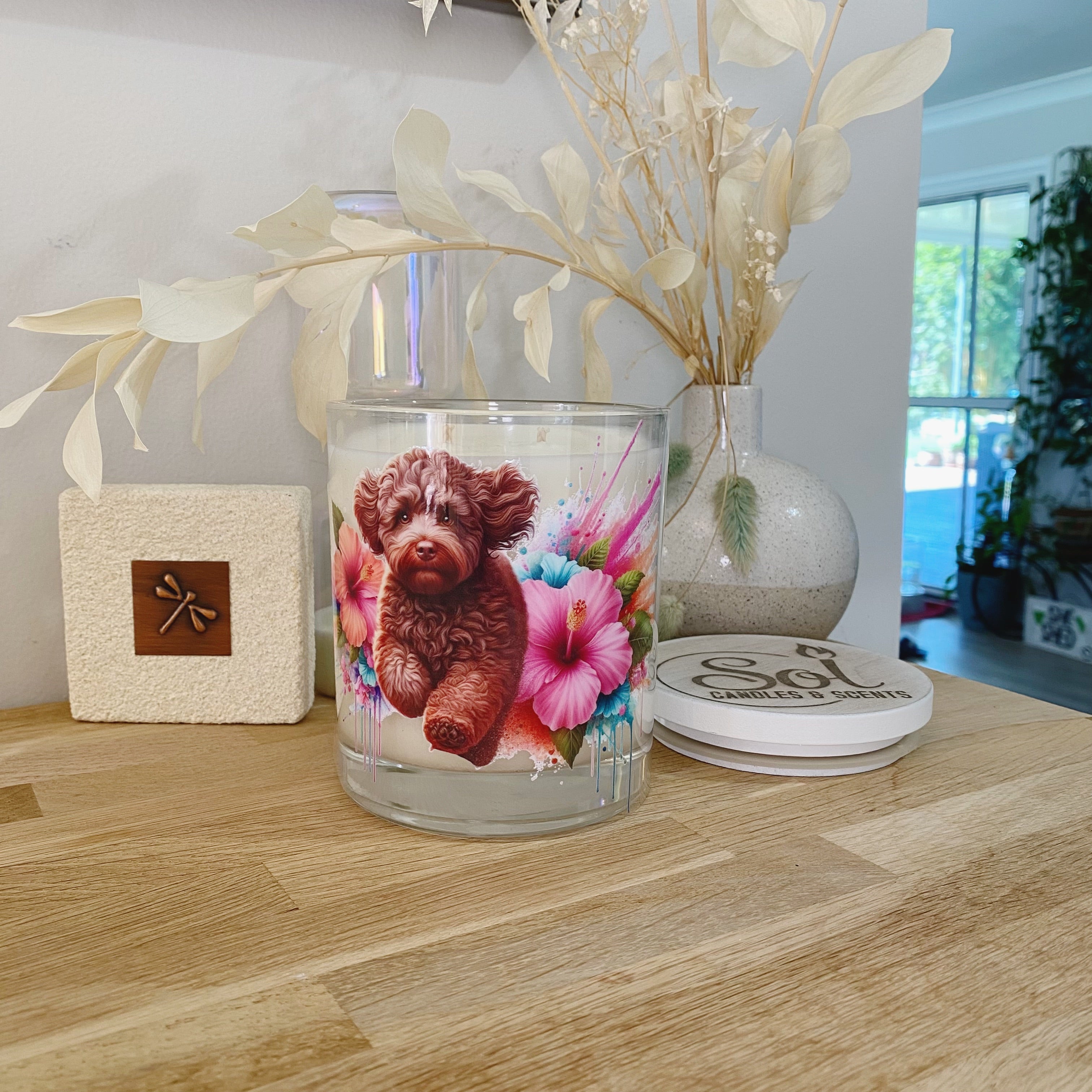 Candle with a Chocolate Cavoodle dog running through hibiscus flowers_Sol Candles &amp; Scents