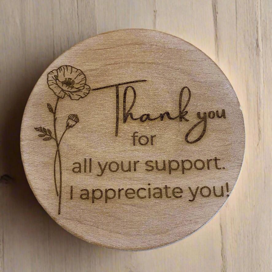 Engraved wooden lid with a floral design and text: &